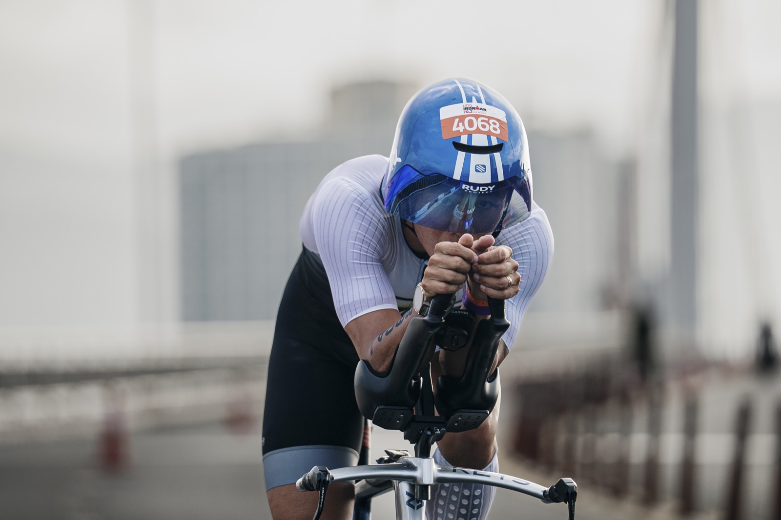 Head down in aero position with Rudy Project helmet, bib 4068, IRONMAN 70.3 Vietnam