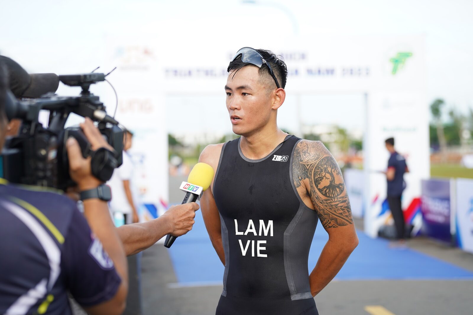 Lâm Quang Nhật being interviewed by a cameraman, race day 2023