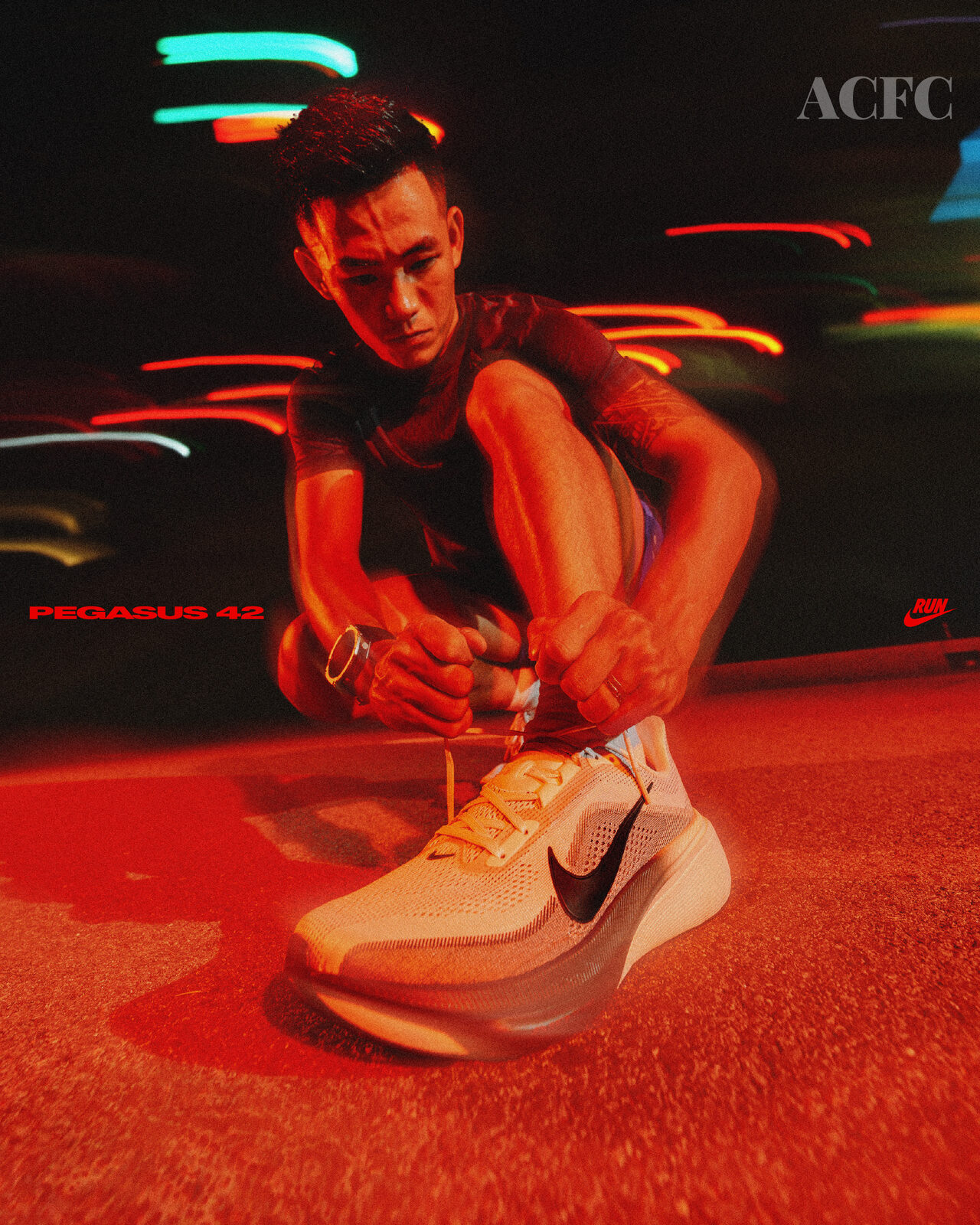 Lacing the Nike Pegasus 42 under streetlights — ACFC campaign, 2026